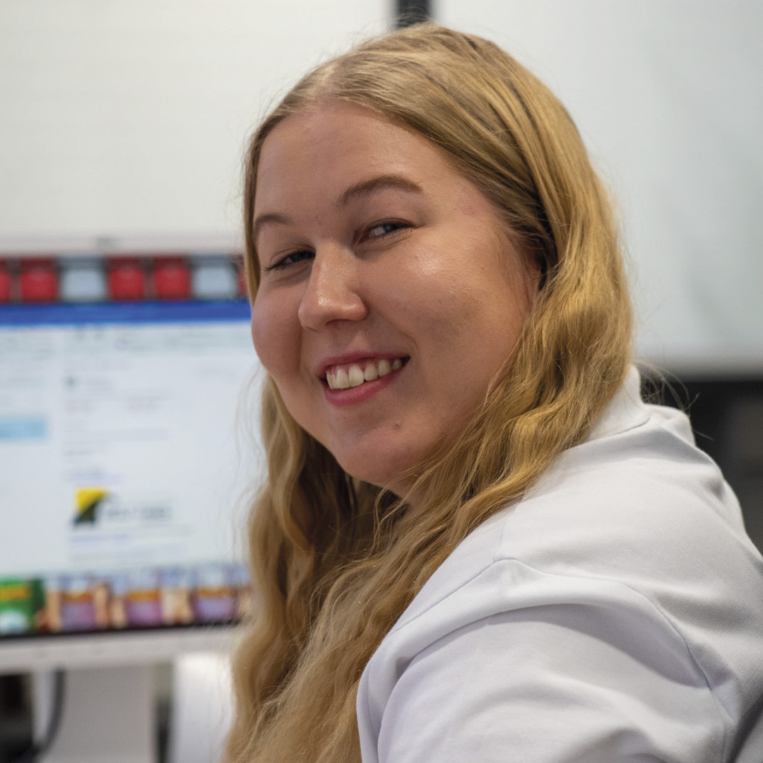 Auszubildende zur Bürokauffrau sitzt an ihrem Rechner im Büro